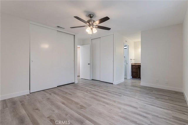 24511 Bridger Rd, Lake Forest, CA 92630 - unfurnished bedroom with light wood-style floors, multiple closets, ensuite bath, baseboards, and a ceiling fan