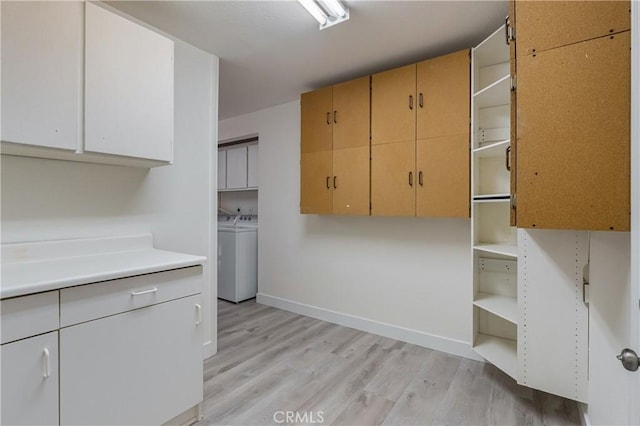 24511 Bridger Rd, Lake Forest, CA 92630 - kitchen featuring open shelves, light wood-type flooring, separate washer and dryer, baseboards, and light countertops