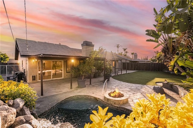 24511 Bridger Rd, Lake Forest, CA 92630 - rear view of property with a fire pit, a patio, a chimney, and stucco siding