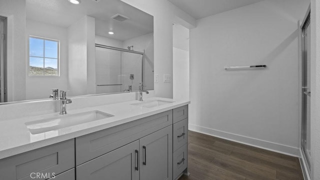 33328 Rusty Ct, French Valley, CA 92596 - full bathroom with baseboards, a sink, wood finished floors, and a shower stall