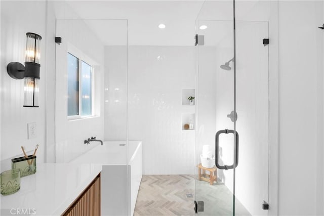 bathroom featuring a bathtub and a stall shower