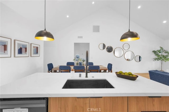 335 N Harvard Blvd, Los Angeles, CA 90004 - kitchen featuring high vaulted ceiling, light stone counters, hanging light fixtures, brown cabinets, and recessed lighting