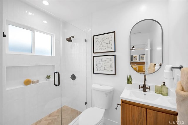 full bathroom with vanity, a stall shower, and toilet