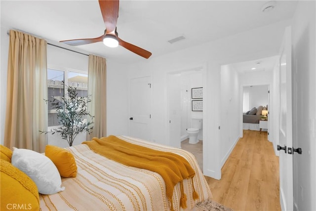 335 N Harvard Blvd, Los Angeles, CA 90004 - bedroom featuring light wood-style floors, connected bathroom, and ceiling fan