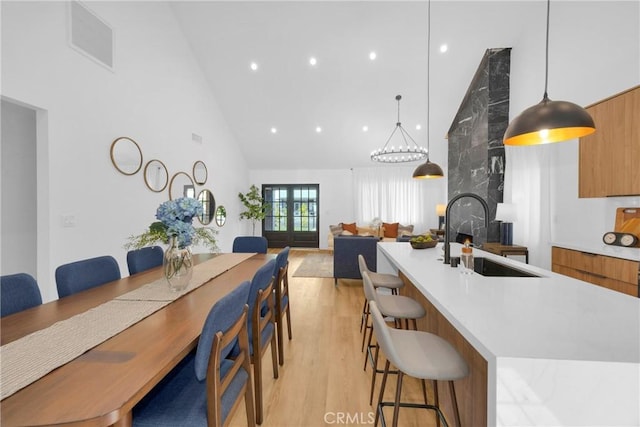 dining area featuring visible vents, recessed lighting, high vaulted ceiling, and light wood-type flooring