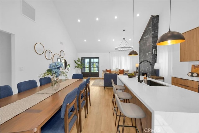 335 N Harvard Blvd, Los Angeles, CA 90004 - dining area with high vaulted ceiling, light wood finished floors, and recessed lighting
