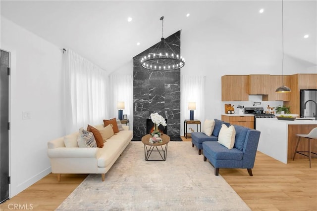 335 N Harvard Blvd, Los Angeles, CA 90004 - living area featuring high vaulted ceiling, a chandelier, light wood-style floors, and recessed lighting