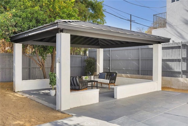 view of patio with a gazebo and fence
