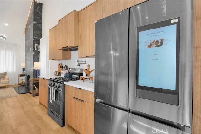 kitchen with light wood-style floors, smart refrigerator, modern cabinets, light countertops, and gas stove