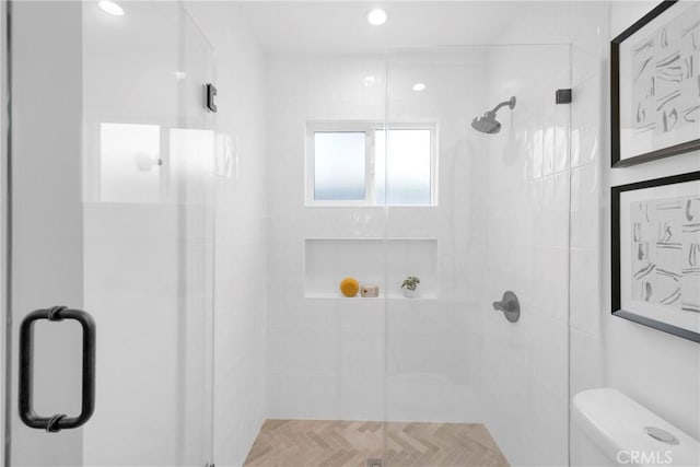 bathroom with recessed lighting, a shower stall, and toilet