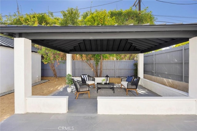 view of patio with an outdoor living space, a fenced backyard, and a gazebo