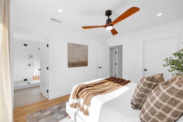 bedroom featuring ensuite bath, visible vents, baseboards, light wood-style floors, and recessed lighting