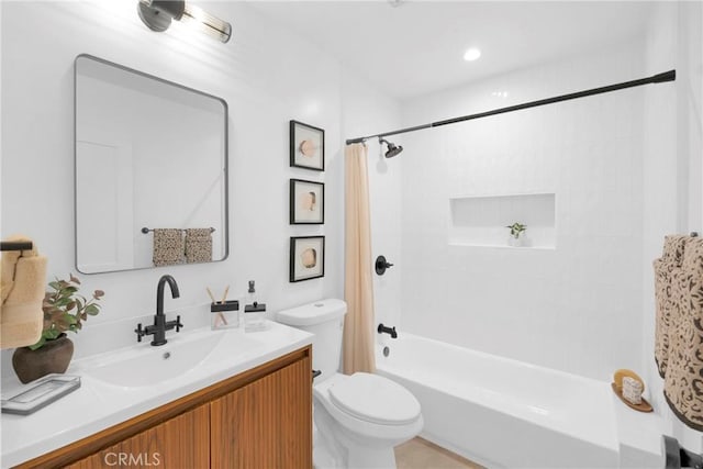 full bathroom featuring vanity, shower / bath combo with shower curtain, and toilet