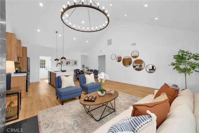 335 N Harvard Blvd, Los Angeles, CA 90004 - living area featuring high vaulted ceiling, light wood-style flooring, a chandelier, and recessed lighting