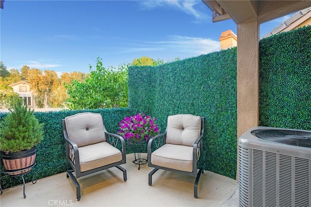 view of patio with fence and central AC