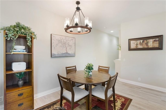 dining room with a chandelier, recessed lighting, baseboards, and light wood-style floors