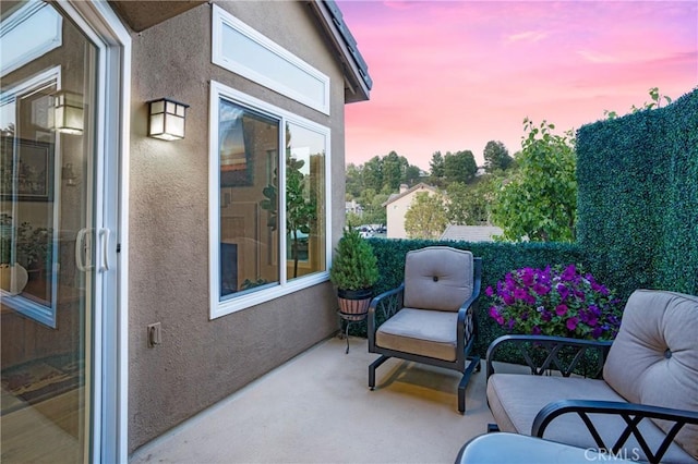 balcony at dusk with a patio area
