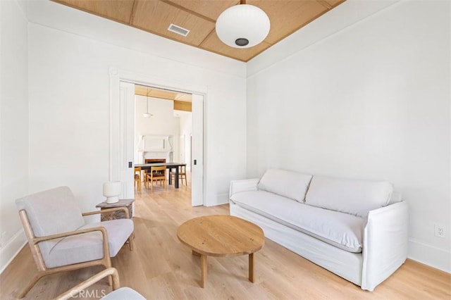 sitting room featuring wooden ceiling, baseboards, light wood-type flooring, and visible vents