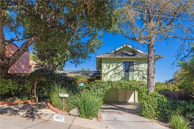 view of front of property with fence and driveway