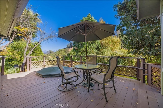 wooden terrace featuring outdoor dining space
