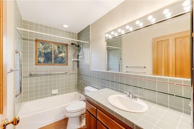 bathroom featuring vanity, tasteful backsplash, bathtub / shower combination, and toilet