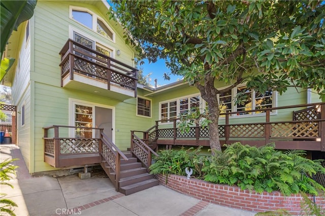 rear view of property featuring a balcony