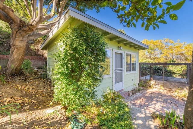 view of side of property featuring a patio and fence