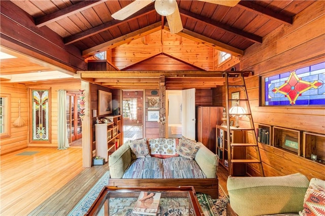 dining area with wooden walls, high vaulted ceiling, wooden ceiling, wood finished floors, and beamed ceiling