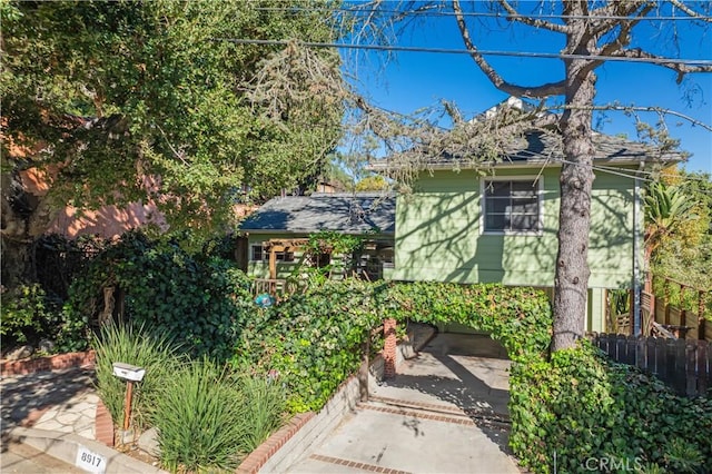 view of front of home featuring fence