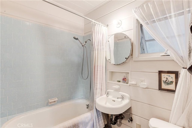 bathroom with toilet, a sink, and shower / bath combo