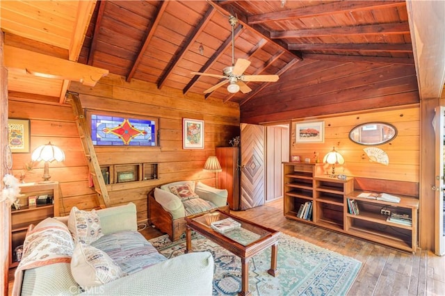 living room with wood walls, a ceiling fan, wooden ceiling, vaulted ceiling with beams, and hardwood / wood-style flooring