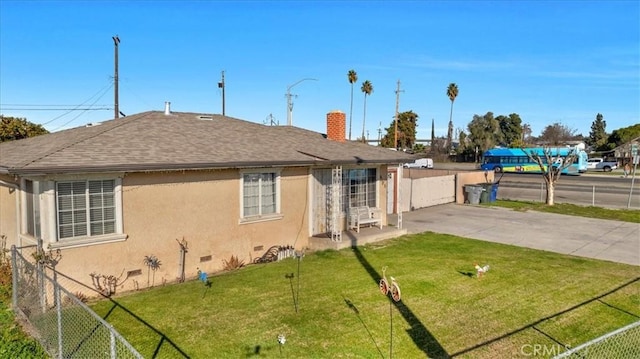 4185 E Turner Ave, Fresno, CA 93702 - back of property with fence, stucco siding, a yard, and a chimney