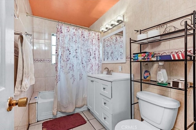 4185 E Turner Ave, Fresno, CA 93702 - bathroom featuring tile walls, tile patterned floors, vanity, toilet, and shower / tub combo with curtain
