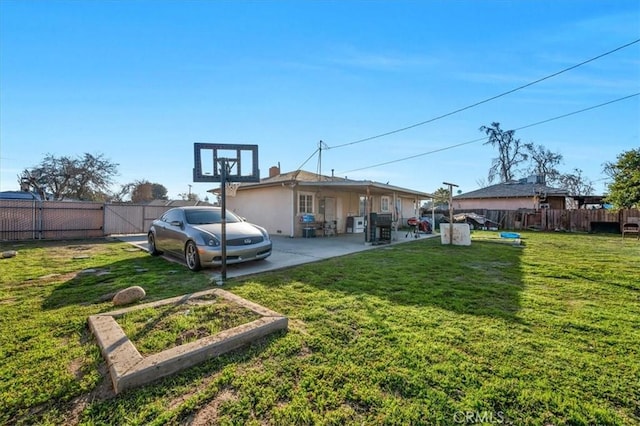 4185 E Turner Ave, Fresno, CA 93702 - back of house with a lawn, a patio, a garden, and a fenced backyard
