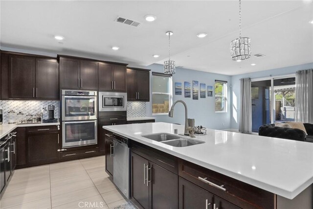 19183 Bension Dr, Saugus, CA 91350 - kitchen featuring stainless steel appliances, light countertops, tasteful backsplash, light tile patterned flooring, and recessed lighting