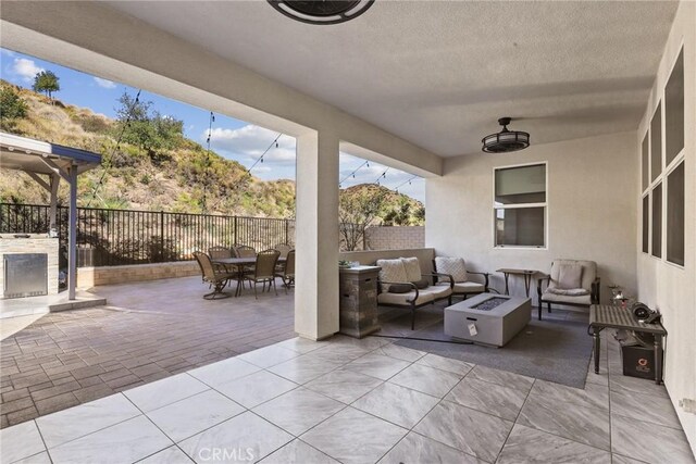 19183 Bension Dr, Saugus, CA 91350 - view of patio with an outdoor living space with a fire pit and outdoor dining space