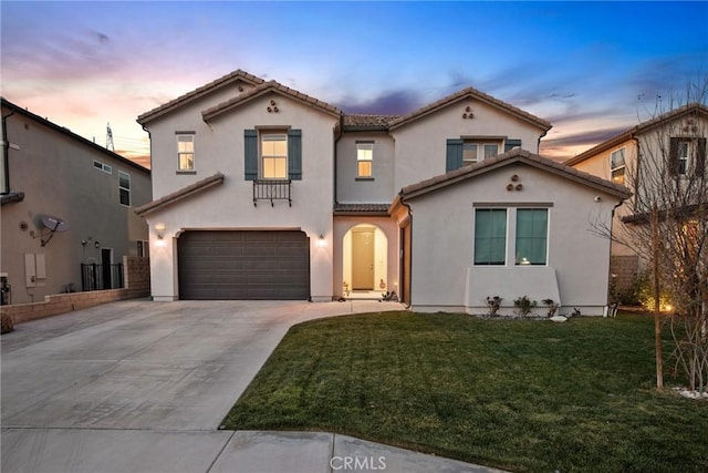 mediterranean / spanish-style home featuring a garage, driveway, stucco siding, a tiled roof, and a yard