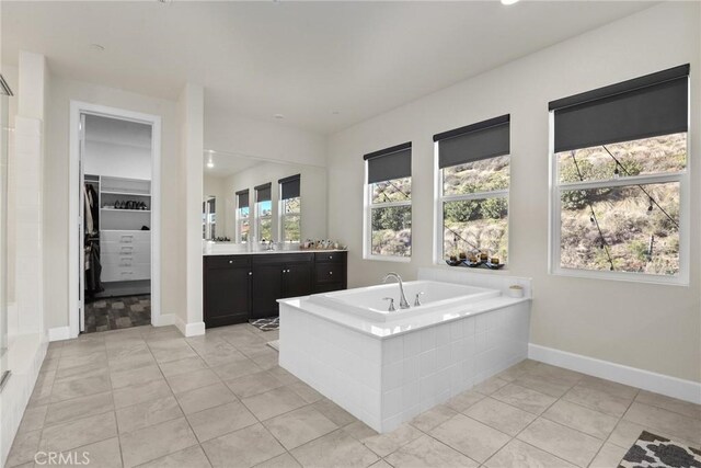 19183 Bension Dr, Saugus, CA 91350 - full bathroom featuring vanity, a garden tub, a spacious closet, tile patterned flooring, and recessed lighting