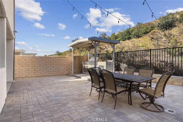19183 Bension Dr, Saugus, CA 91350 - fenced backyard featuring area for grilling, outdoor dining space, and a patio