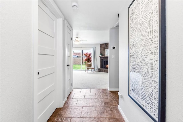 6222 Shawnee Rd, Westminster, CA 92683 - hall featuring stone tile flooring, baseboards, and carpet floors