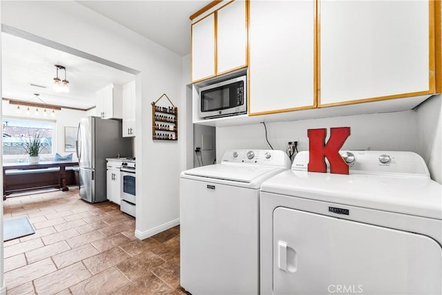 6222 Shawnee Rd, Westminster, CA 92683 - laundry room featuring washing machine and dryer, baseboards, and stone finish flooring