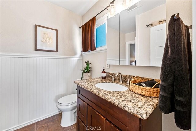 6222 Shawnee Rd, Westminster, CA 92683 - bathroom with vanity, toilet, and a wainscoted wall