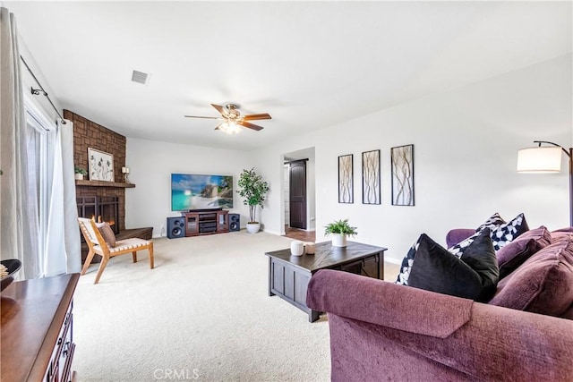 6222 Shawnee Rd, Westminster, CA 92683 - living area with light carpet, a large fireplace, and a ceiling fan