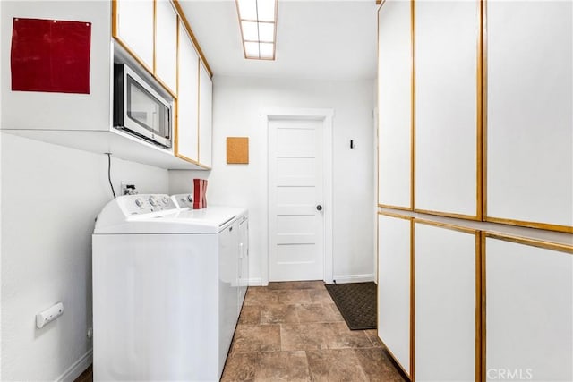 6222 Shawnee Rd, Westminster, CA 92683 - washroom featuring separate washer and dryer, baseboards, cabinet space, and stone finish flooring
