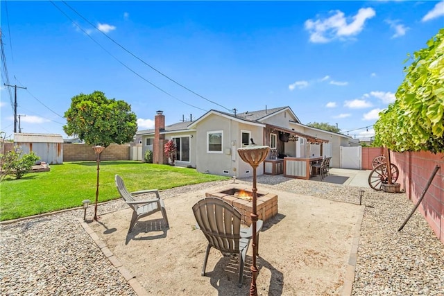 6222 Shawnee Rd, Westminster, CA 92683 - back of property featuring an outdoor fire pit, a patio, a storage shed, an outdoor structure, and a chimney