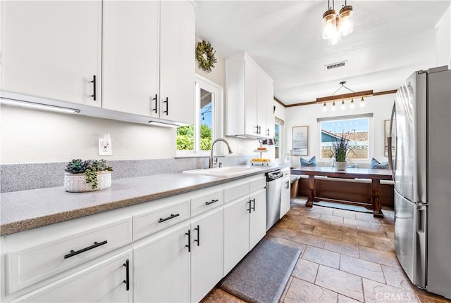 6222 Shawnee Rd, Westminster, CA 92683 - kitchen featuring appliances with stainless steel finishes, a sink, stone tile floors, white cabinetry, and light stone countertops