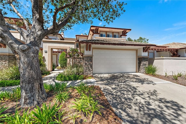27 Birdie Ln, Coto De Caza, CA 92679 - view of front facade with stucco siding, an attached garage, driveway, and stone siding