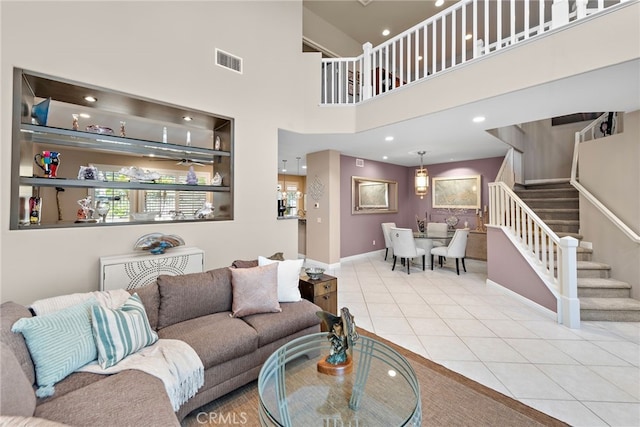 27 Birdie Ln, Coto De Caza, CA 92679 - living area featuring visible vents, stairs, baseboards, a high ceiling, and tile patterned floors