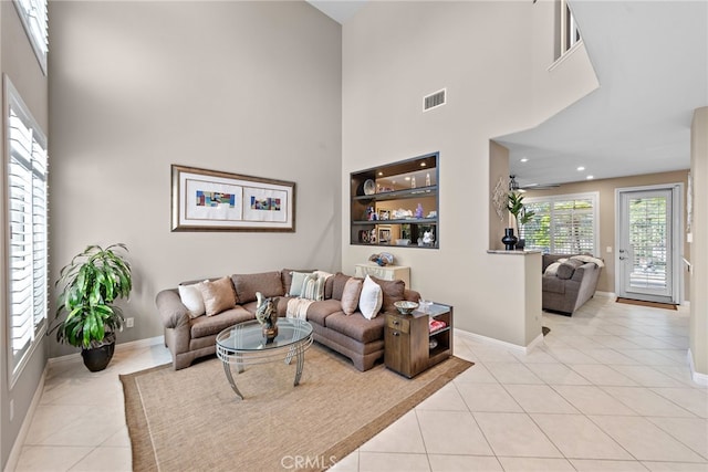 27 Birdie Ln, Coto De Caza, CA 92679 - living area featuring light tile patterned flooring, baseboards, visible vents, and a towering ceiling