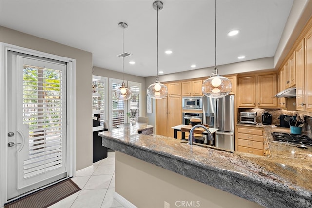 27 Birdie Ln, Coto De Caza, CA 92679 - kitchen with light brown cabinets, under cabinet range hood, light stone counters, a sink, and stainless steel appliances
